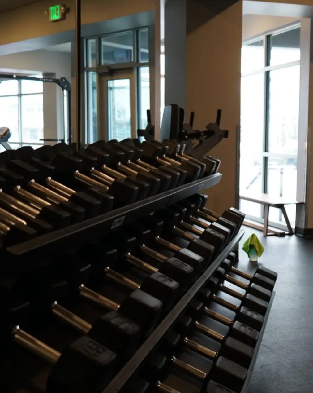 A full dumbbell rack beside the mirrored wall at PKFit Park Street