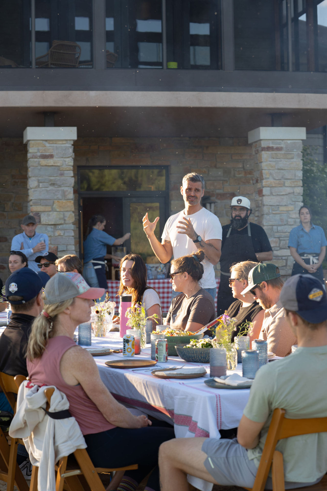 Retreat guests gathered for an outdoor dinner on the stone terrace at Flynn Creek Farm