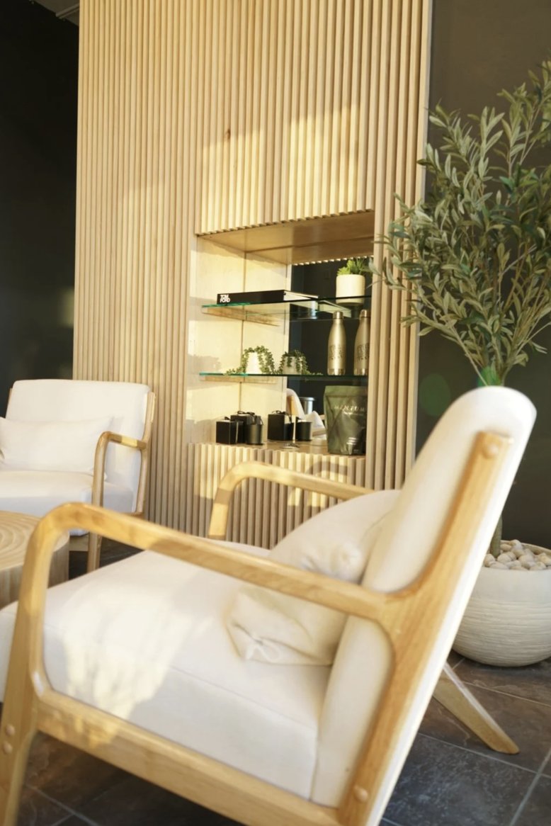 The University Row recovery lounge with lounge chairs and a retail shelf
