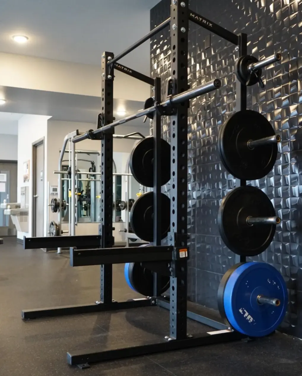 A Matrix squat rack with weight plates at PKFit Park Street