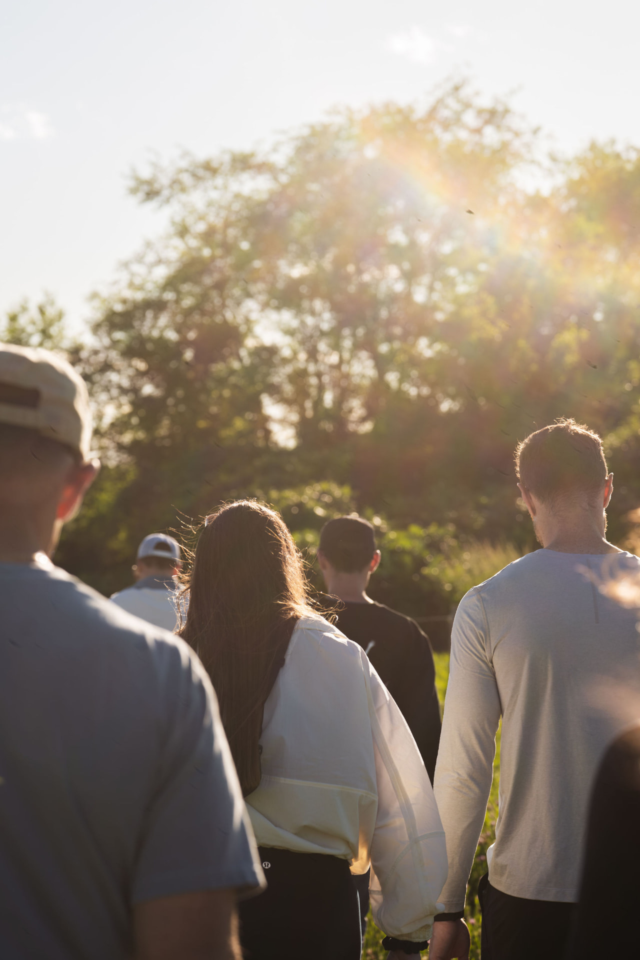 Retreat guests walking toward a grove of trees in the late afternoon light