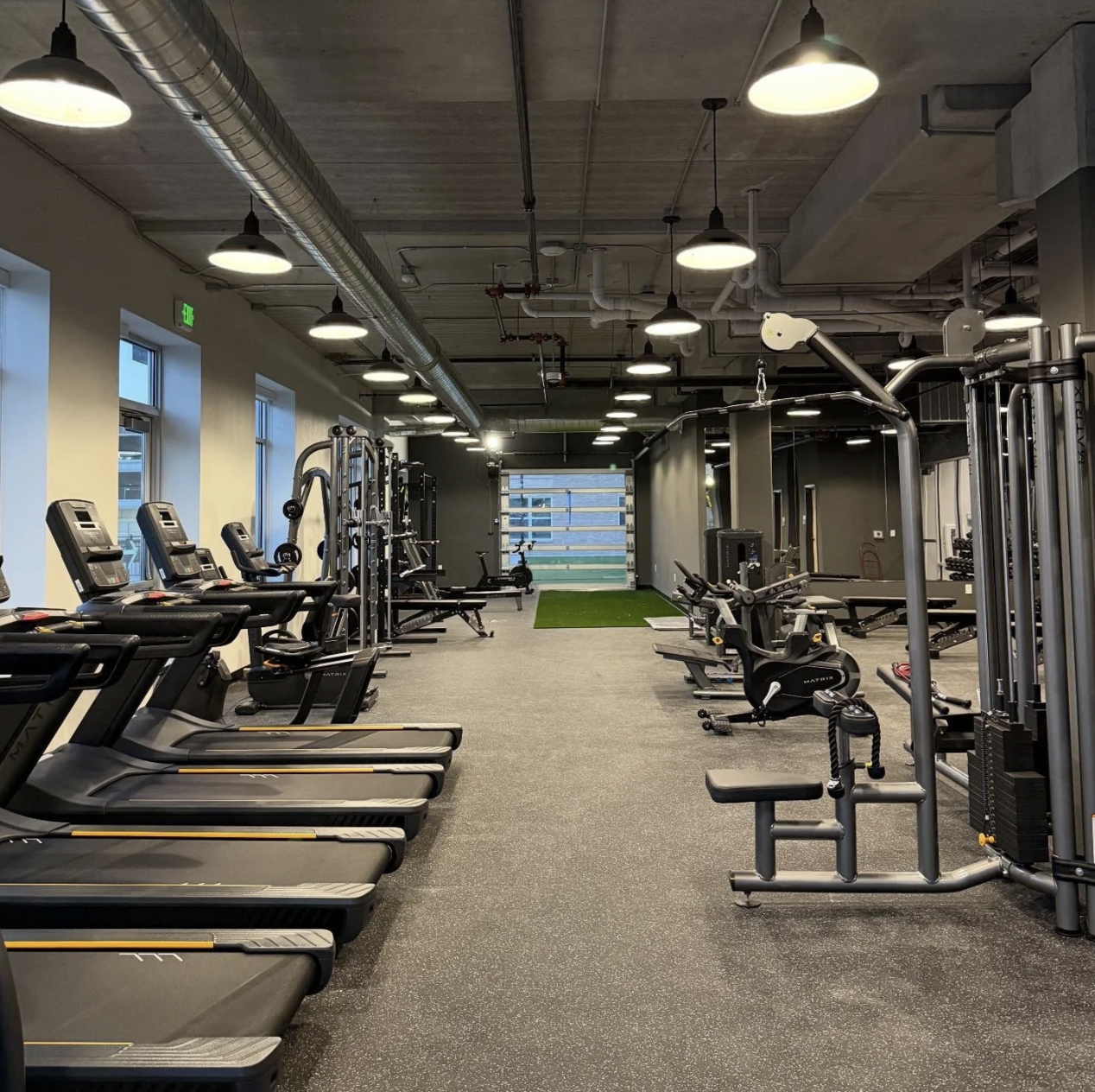 Treadmills and cable machines on the open gym floor at PKFit Wausau